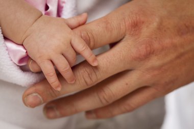 Baby Girl Hand Holding Rough Finger of Dad clipart