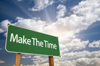 Make The Time Green Road Sign and Clouds clipart