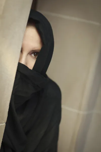 Mujer islámica cautelosa en el panel de la ventana con Burqa o Niqab —  Fotos de Stock
