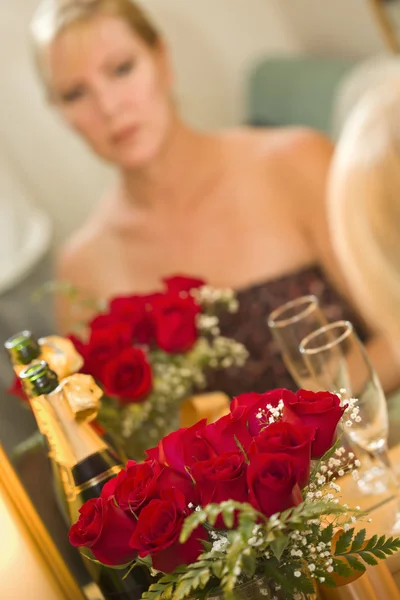Pensive Blonde Sits at Mirror Near Champagne and Roses — Stok Foto