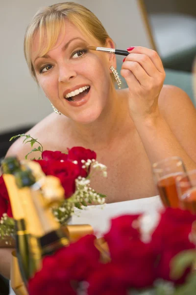 Blonde Woman Applies Makeup at Mirror Near Champagne and Roses — Stock Photo, Image