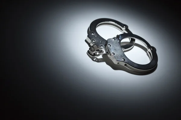 Abstract Pair of Handcuffs Under Spot Light - Text Room — Stock Photo, Image