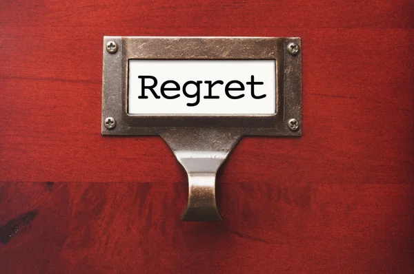 Lustrous Wooden Cabinet with Regret File Label — Stock Photo, Image