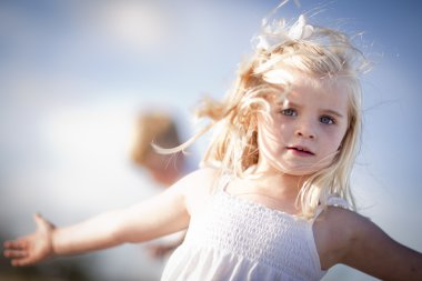 Adorable Blue Eyed Girl Playing Outside clipart