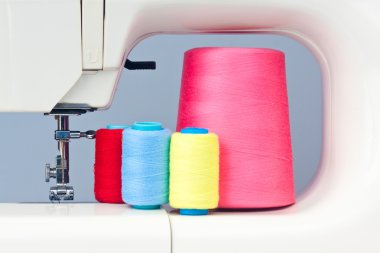 Sewing machine and thread bobbins clipart