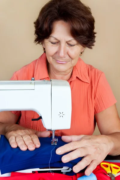 Hispanic woman working on a sewing machine Stock Image