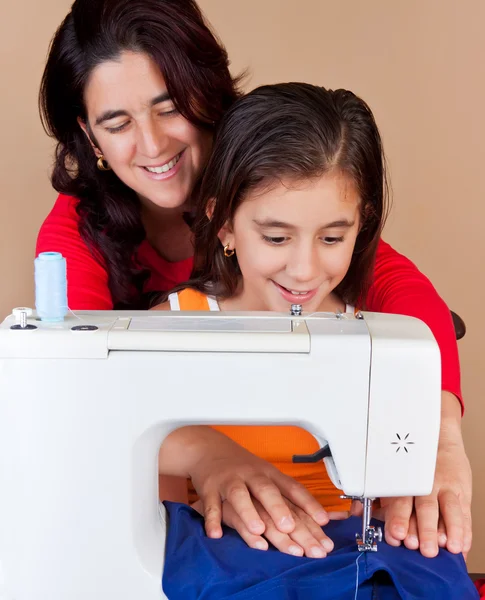 Mother and daughter sewing together — Stock Photo, Image