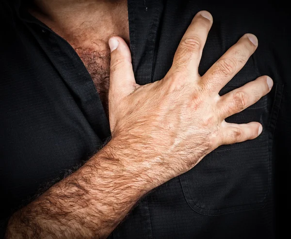 Close up of a hand grabbing a chest — Stock Photo, Image