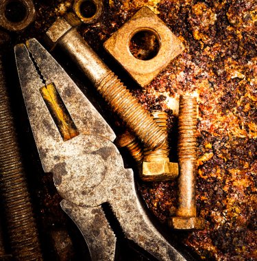 Macro of tools on a rusty background clipart