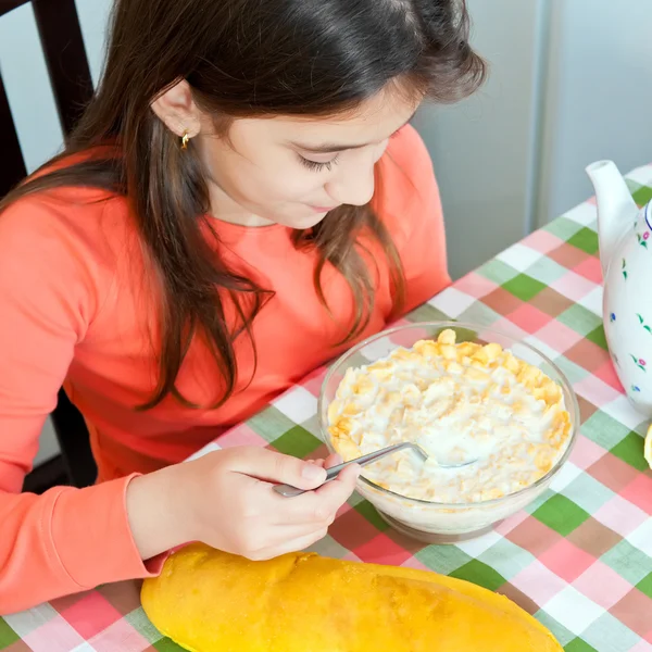 Beautiful hispanic girl eating breakfast on a bowl with milk and cereal — Stock Photo, Image