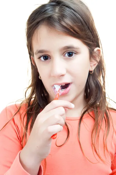Small latin girl washing her teeth isolated on white — Stock Photo, Image