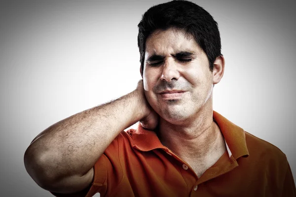 Very stressed hispanic man suffering from neck pain — Stock Photo, Image