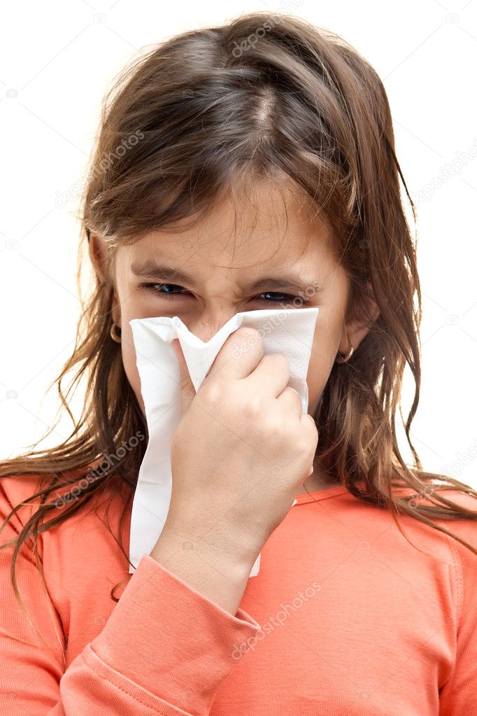 Girl sneezing on a paper tissue isolated on white
