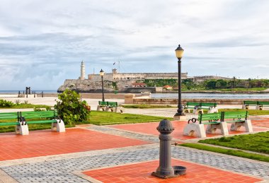 Park in Havana with the iconic El Morro castle in the background clipart