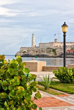 Park in Havana with the iconic El Morro castle in the background clipart