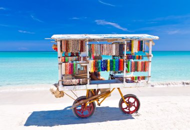 Cart selling typical souvenirs on the famous cuban beach of Varadero clipart