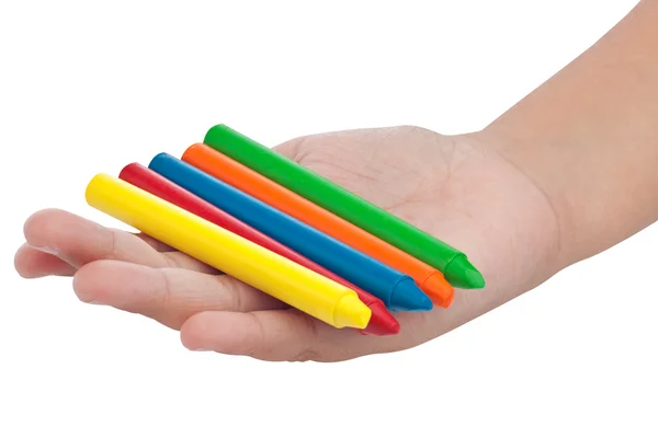 Mão de criança com um grupo de lápis de cor isolado em branco — Fotografia de Stock