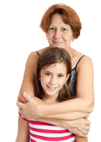 Lateinische Großmutter umarmt ihre schöne Enkelin isoliert auf weiß — Stockfoto