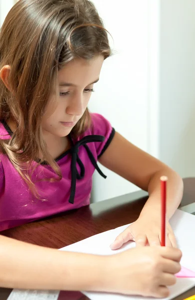 Small hispanic girl working on her school project at home — Stock Photo, Image