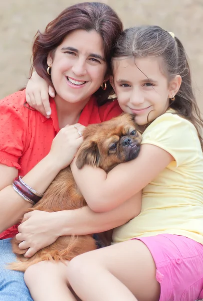 Latin family with a small pekingese dog — Stok fotoğraf