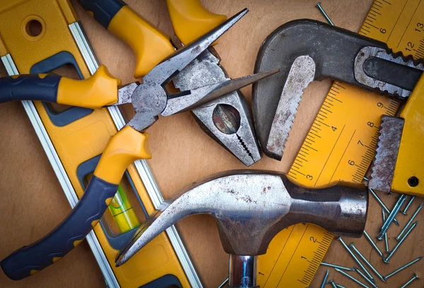 Set of tools over a wooden panel — Stock Photo, Image