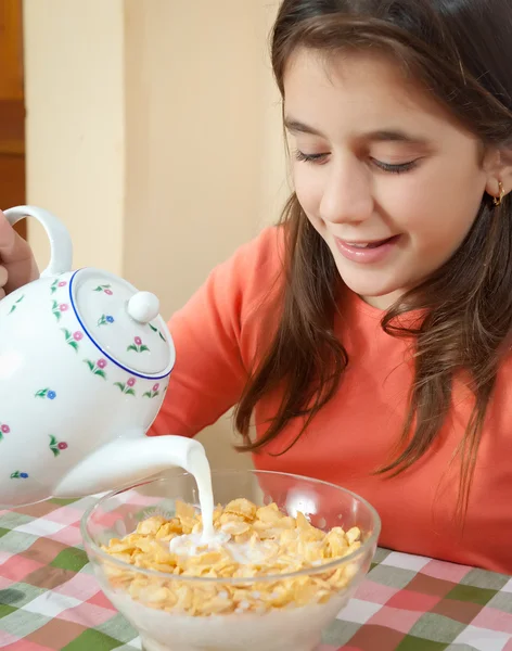 Cute latin girl eating breakfast at home — Stock Photo, Image