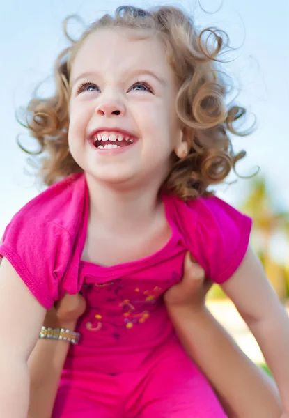 Beautiful baby girl up in the air — Stock Photo, Image