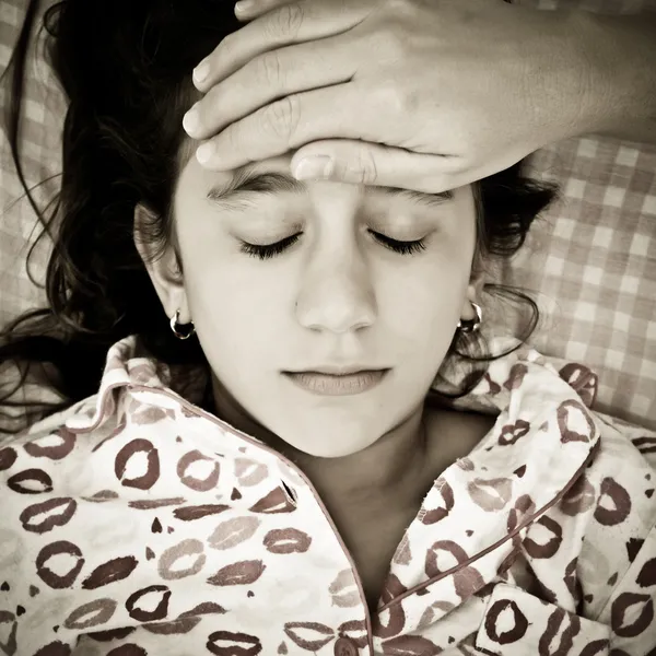 Sad portrait of a small girl sick with fever — Stock Photo, Image