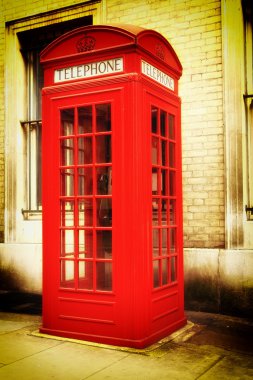 Retro image of a typical red London phone booth clipart