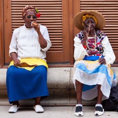 Women in Old Havana smoking cuban cigars clipart