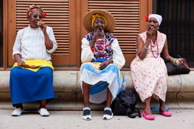 Women in Old Havana smoking cuban cigars clipart