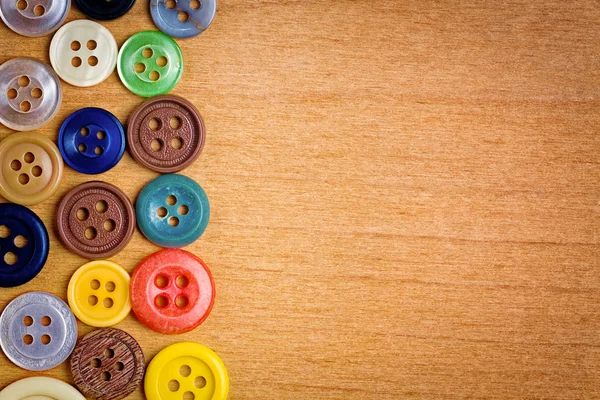 Colorful sewing buttons on a wood background — Stock Photo, Image