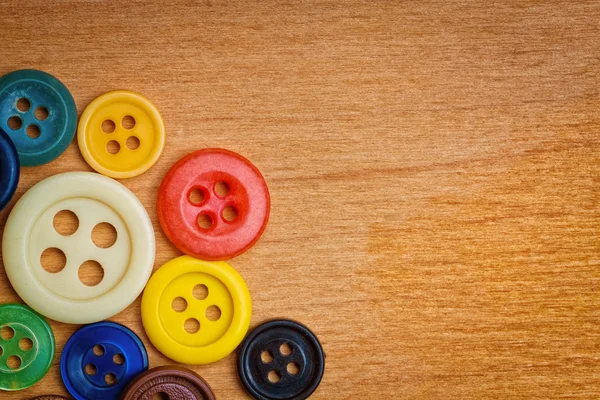 Colorful sewing buttons on a wood background — Stock Photo, Image