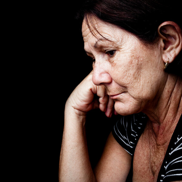 Sad and worried old woman