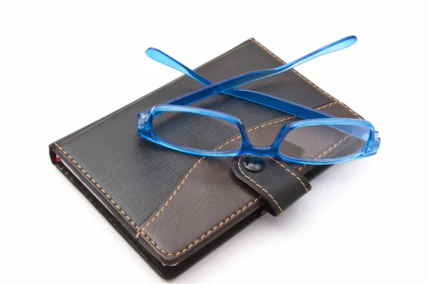 Caderno e óculos — Fotografia de Stock