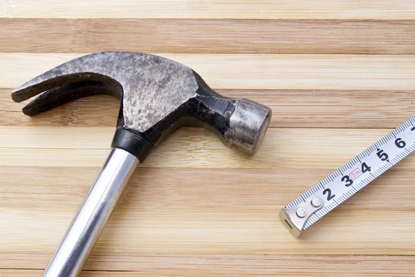 Old hammer and tape measure — Stock Photo, Image