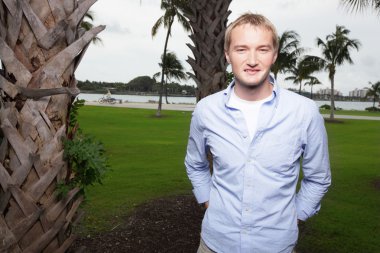 Man posing in a park at Miami Beach clipart