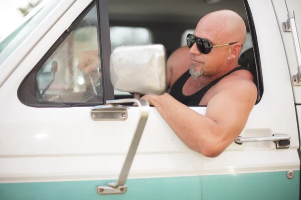 Tough guy driving a truck — Stock Photo, Image