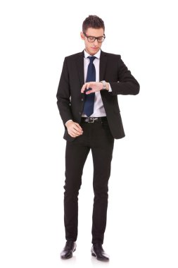 Business man wearing glasses looking at watch clipart