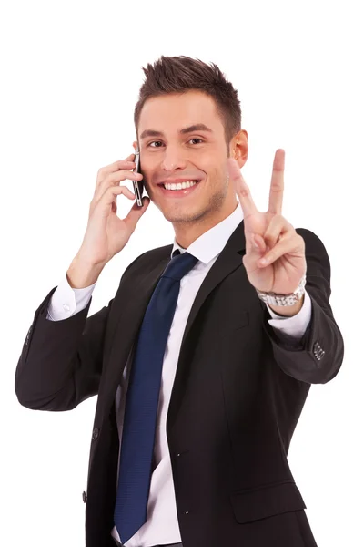 Business man making victory sign on phone — Stock Photo, Image