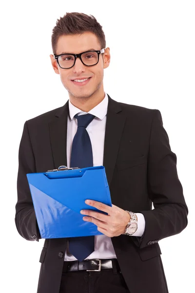Business man wearing glasses is writing on clipboard — Stock Photo, Image
