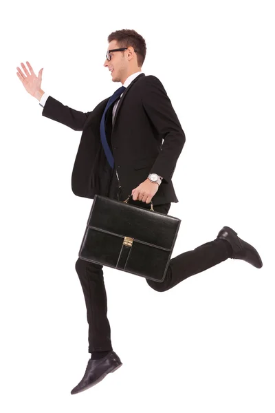 Business man with glasses and suitcase jumping — Stock Photo, Image