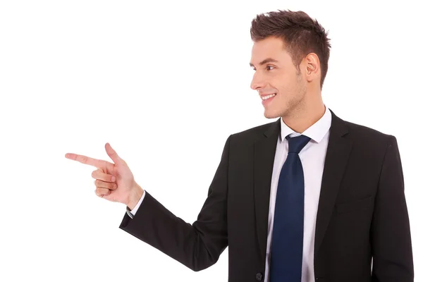 Young business man pointing to the side Royalty Free Stock Images