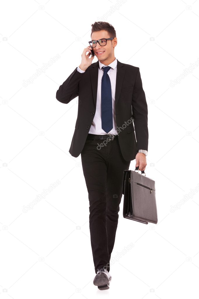 Business man walking and talking on phone