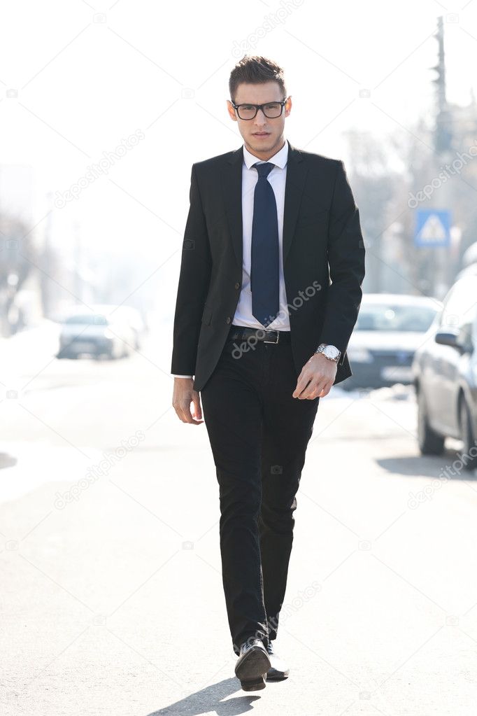 Business man walking towards the camera