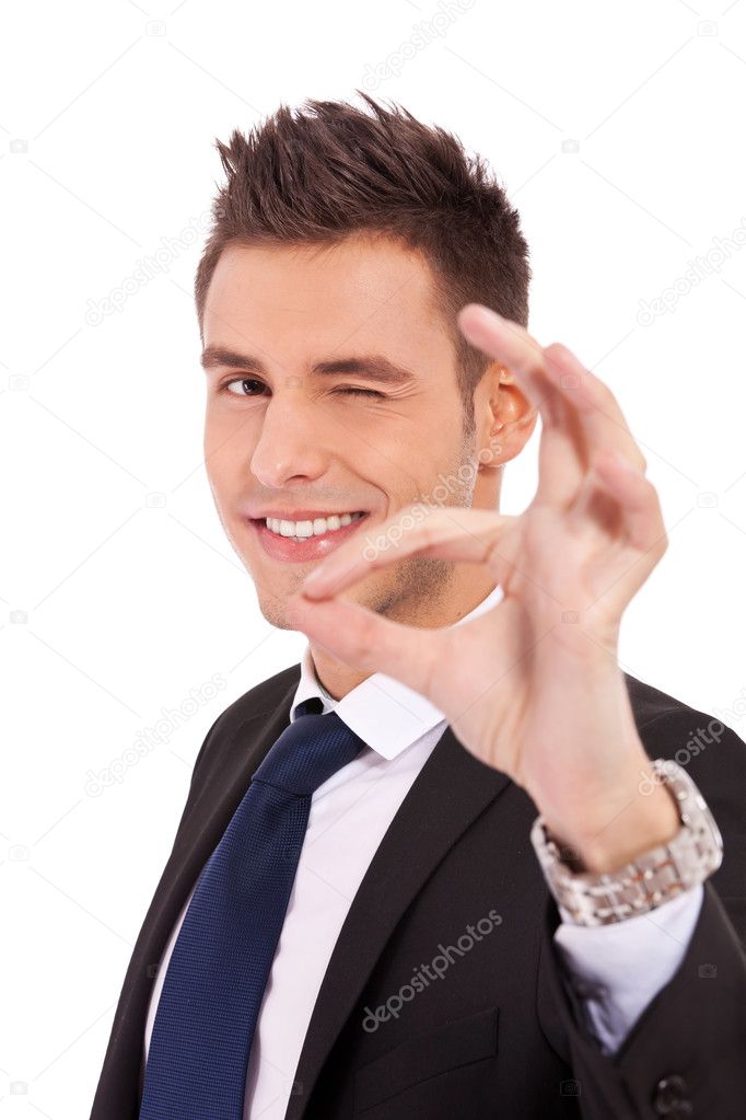 Business man winking with ok sign