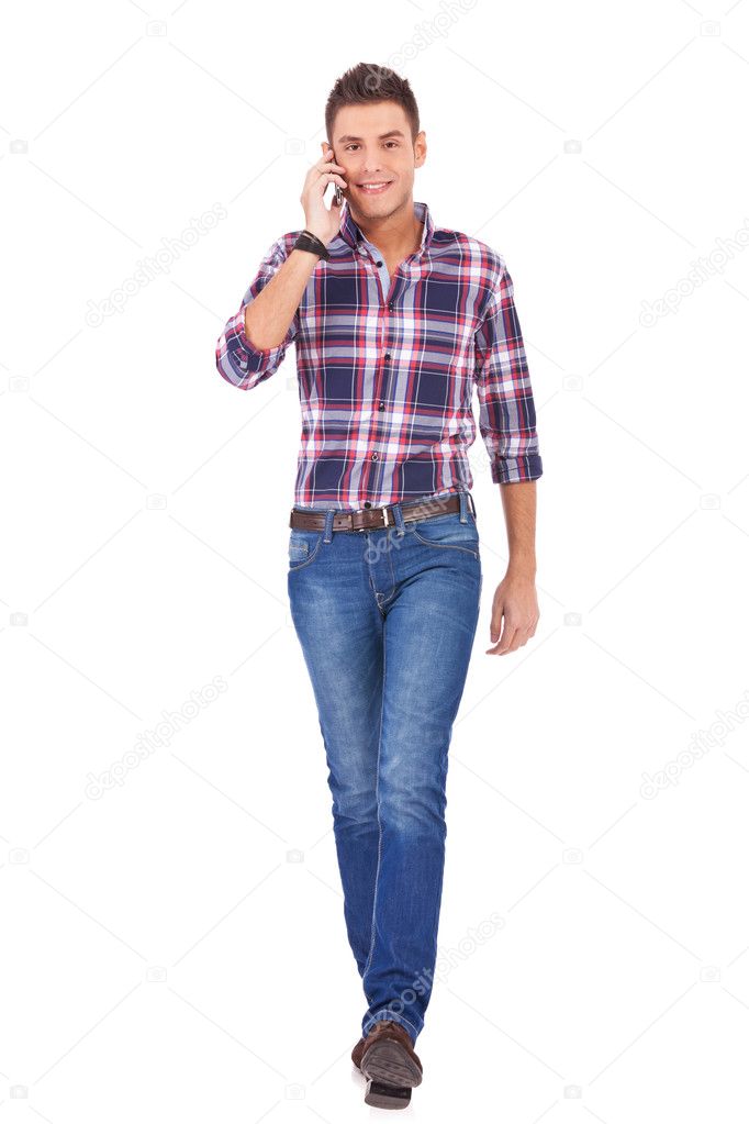 Casual man walking and talking on phone