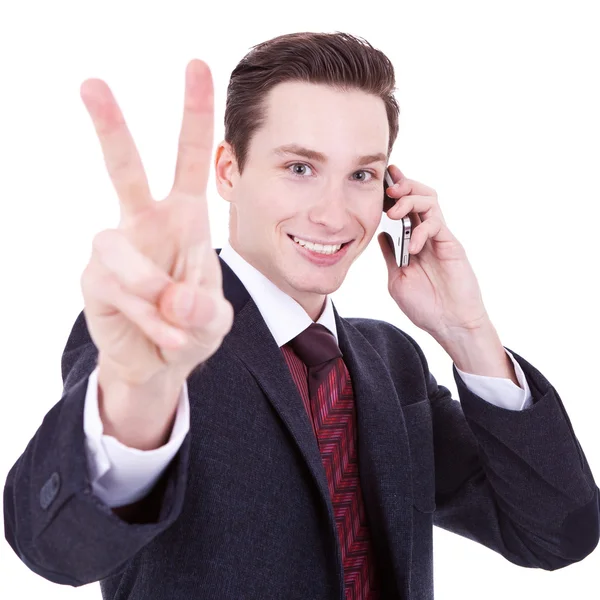 Homem de negócios fazendo sinal de vitória no telefone — Fotografia de Stock