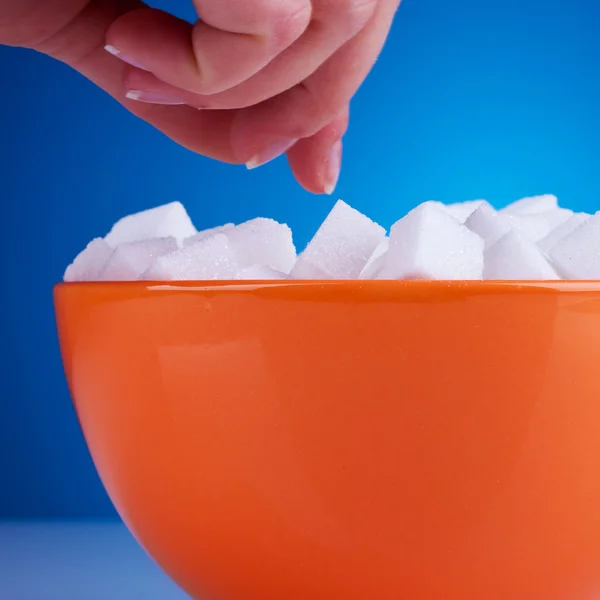 Woman reaching for some sugar cubes — Stock Photo, Image