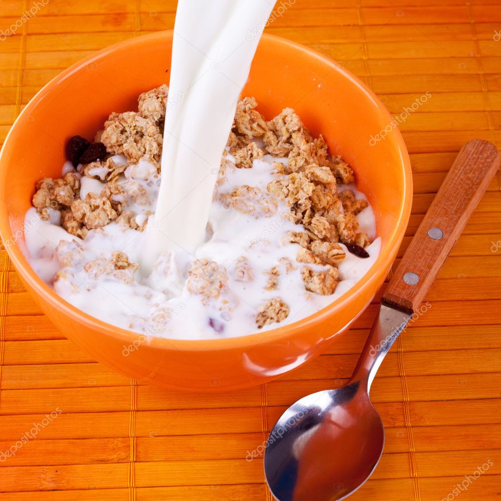 Milk pouring on cereal